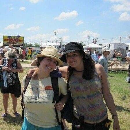 Two young woman wearing hats in the sunshine at an outdoor festival, Rewire, Instant Messaging, friendship