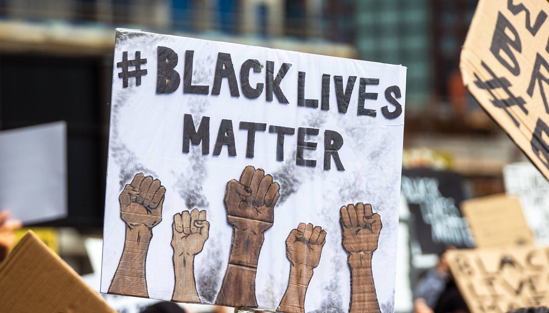 a sign at a Black Lives Matter protest. Rewire, PBS, our future, emergency powers, protests