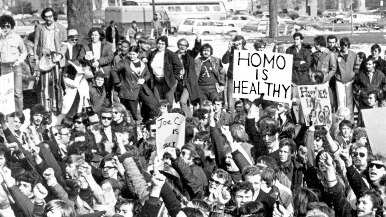 An old photograph of a group of LGBTQ activists. Rewire, PBS, Cured