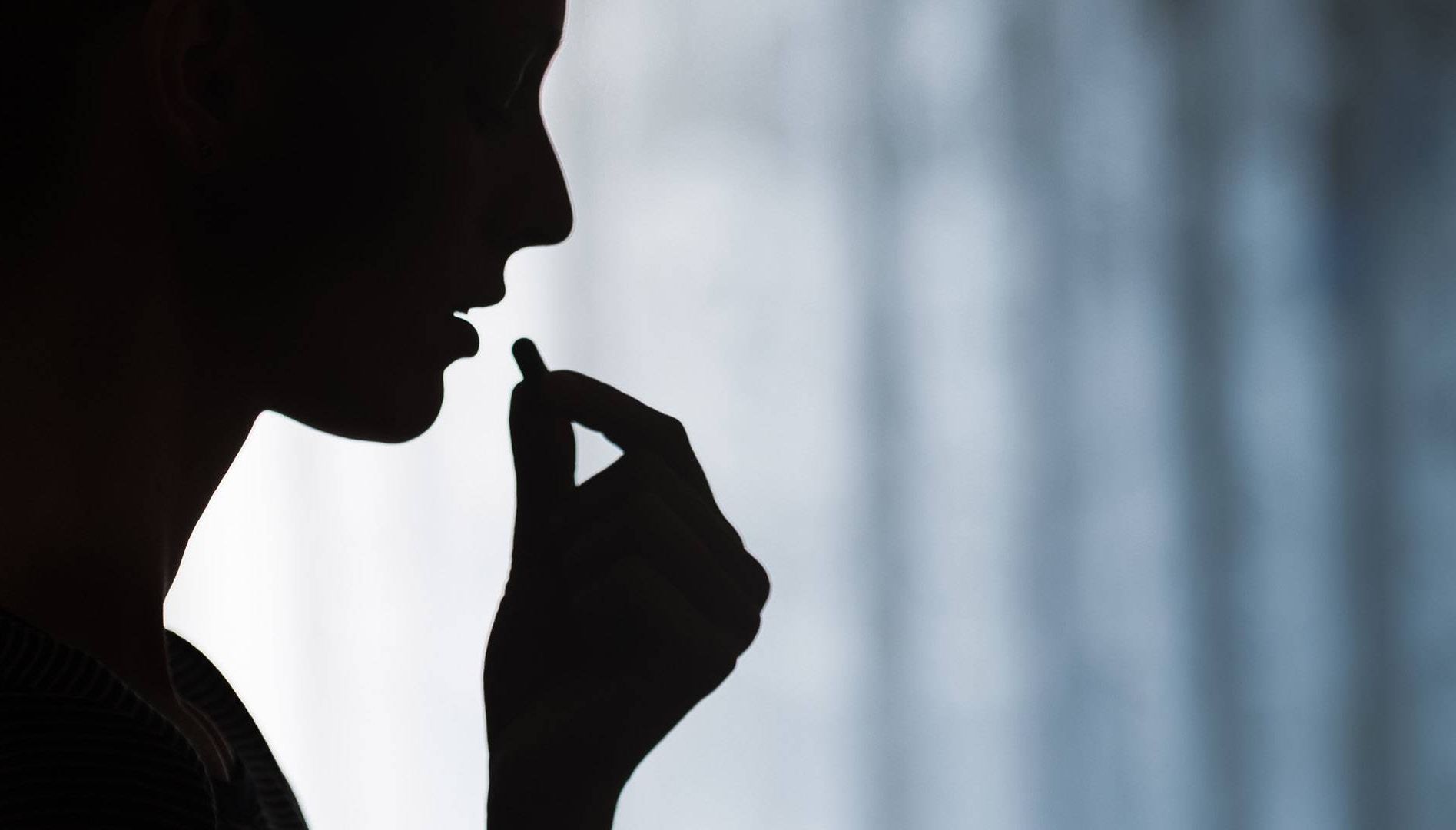 woman taking pill. REWIRE PBS love heartbreak